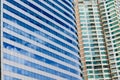 Blue sky and clouds reflected on the glass of office business buildings in the city center on a bright sunny day Royalty Free Stock Photo