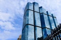Blue sky and clouds reflected on the glass of office business buildings in the city center on a bright sunny day Royalty Free Stock Photo