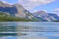 Blue sky and clouds reflecting on Upper Waterton Lake Royalty Free Stock Photo