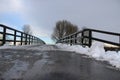 The bridge in the park under the snow in the winter.