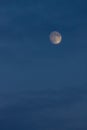 Blue sky with clouds and a round full moon. A beautiful night sky. Moonlight evening light