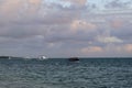 Blue sky with clouds and sea with boats in the sunset background Royalty Free Stock Photo