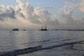 Blue sky with clouds and sea with boats in the sunset background Royalty Free Stock Photo