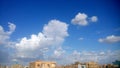 Blue sky, clouds, and a small rainbow