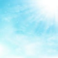 Blue sky and clouds with sun burst and rays background. Royalty Free Stock Photo