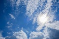 Blue sky with clouds and sun reflection. Sun shines bright in the daytime in summer Royalty Free Stock Photo