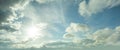 Blue sky, clouds and sun reflection. Summer sun shines bright in the daytime Royalty Free Stock Photo