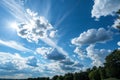 Blue sky with clouds and sunlight creating abstract shapes Royalty Free Stock Photo