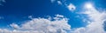 Blue sky with clouds in sunlight, wide cloudscape background panorama Royalty Free Stock Photo