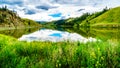 Blue Sky, Clouds and surrounding Mountains reflecting on the smooth water surface of Trapp Lake Royalty Free Stock Photo