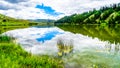 Blue Sky, Clouds and surrounding Mountains reflecting on the smooth water surface of Trapp Lake Royalty Free Stock Photo