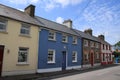 Blue sky with clouds and terraced houses in the village Dingle in county Kerry in Ireland in the summer.