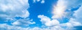 Blue sky, cloudscape background banner panorama , with clouds and sun reflection / sunshine sunbeams Royalty Free Stock Photo