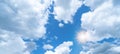 Blue sky, cloudscape background banner panorama , with clouds and sun reflection / sunshine sunbeams Royalty Free Stock Photo