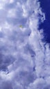 the blue sky is almost completely covered with white clouds with a colored kite Royalty Free Stock Photo