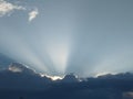 Blue sky with dark blue clouds. the sun behind the clouds.