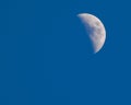 Blue sky daytime half moon
