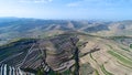 Aerial view of farm field hills, terraced valley with massive agricutlure