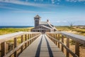 Blue sky and dunes with grass in front of the life saving station building in Provincetown Royalty Free Stock Photo