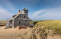 Blue sky and dunes with grass in front of the life saving station building in Provincetown Royalty Free Stock Photo