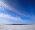 Blue Sky and a Field Covered With Snow, a Rural Landscape. Royalty Free Stock Photo