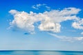 Blue sky with fluffy clouds, over clear sea water, outdoor at no Royalty Free Stock Photo