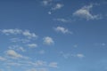 Blue sky with fluffy clouds and partial moon - background or replacement