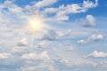 Blue sky with fluffy clouds and sun, sunlight, yellow sun rays Royalty Free Stock Photo