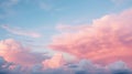 Blue sky with fluffy pink clouds at sunset, dawn of the day. Warm pastel colors, serene romantic background. Royalty Free Stock Photo