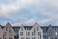 Blue sky full of clouds over estate buildings with flat facades Royalty Free Stock Photo