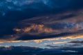 Blue sky with gold clouds - dramatic sunset, beautiful natural background. Setting sun illuminates the clouds Royalty Free Stock Photo