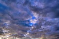 Blue sky with gold clouds - dramatic sunset, beautiful natural background. Setting sun illuminates the clouds Royalty Free Stock Photo