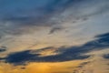 Blue sky with gold clouds - dramatic sunset, beautiful natural background. Setting sun illuminates the clouds Royalty Free Stock Photo