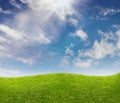 Blue sky and green grass meadow