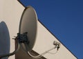 Blue sky on its background white old satellite dish on a building Royalty Free Stock Photo