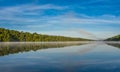 Blue sky misty summer morning in middle of Corry lake.