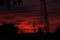 Red sky at night and high voltage pole and wire . Royalty Free Stock Photo