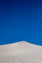 Blue Sky Over Crest of White Dune Royalty Free Stock Photo