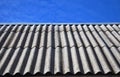 Blue sky over the dangerous asbestos old roof tiles Royalty Free Stock Photo