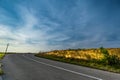 Asphalt road during Sunset. Field of golden Royalty Free Stock Photo