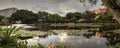 Blue sky over a pond and fountain at the Garden of Hope and Courage