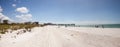 Blue sky over white sand and green beach grass of Tigertail Beach