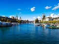 Blue sky painted clouds zurich old town historic city centre church tower bridge view pier ferry boats switzerland sunny