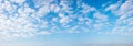 blue sky panorama with fleecy white clouds background Royalty Free Stock Photo