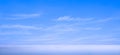 Blue Sky Panoramic Background with beautiful softly Cloud streaks Over Sea with daylight reflection on Water surface Royalty Free Stock Photo