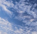 Blue sky with puffy white clouds and a half moon Royalty Free Stock Photo