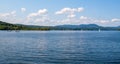 Blue sky and puffy white clouds over calm Lake Memphremagog Royalty Free Stock Photo