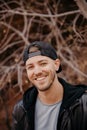 Portrait of Young Good Looking Handsome Man Smiling in Jacket Outside in Isolated Field of Tall Grass Royalty Free Stock Photo