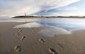 Blue sky reflected in sea water on beach Royalty Free Stock Photo