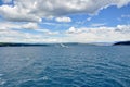 Ferry boat in Adriatic Sea with scenic blue sky and white clouds, near island Cres